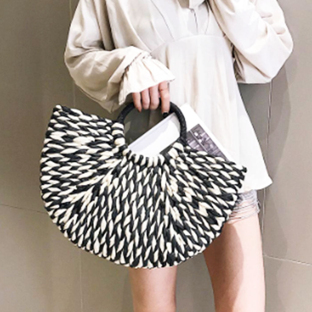 The Heather Half Moon Straw Tote Bag in monochrome