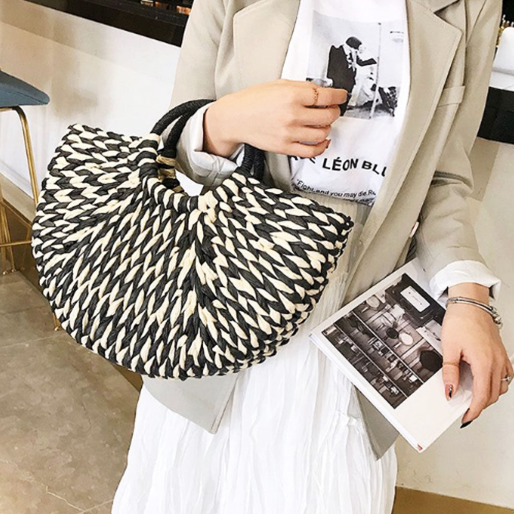 The Heather Half Moon Straw Tote Bag in monochrome